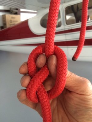 Reach thru the loop and pull the upper side of the rope thru the loop.